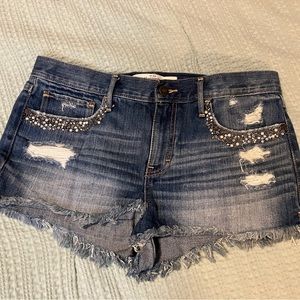 Size 10/30 Abercrombie & Fitch cutoff jean shorts with front pocket bead detail.